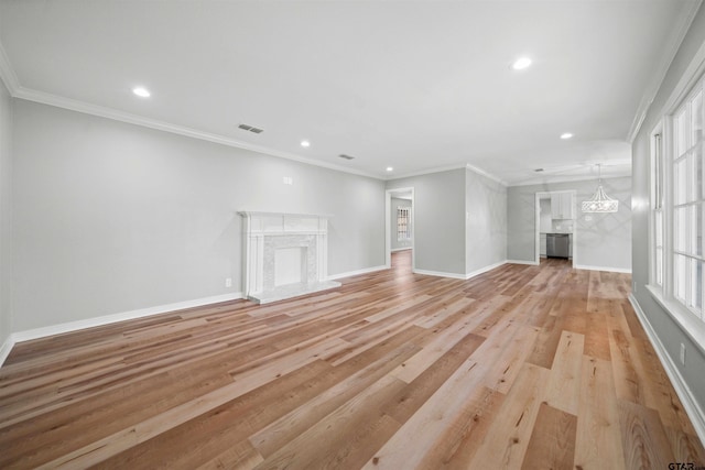 unfurnished living room featuring light hardwood / wood-style floors and ornamental molding