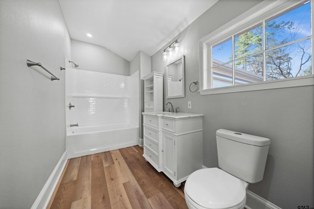 full bathroom with hardwood / wood-style floors, vanity, lofted ceiling, toilet, and shower / bathtub combination