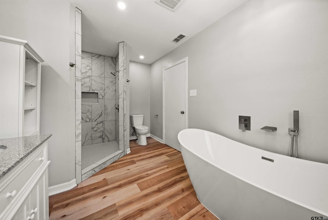 full bathroom featuring independent shower and bath, vanity, wood-type flooring, and toilet