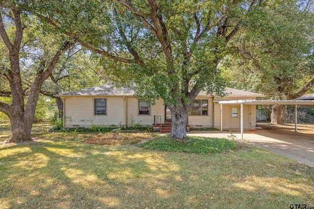 single story home with a front yard and a carport