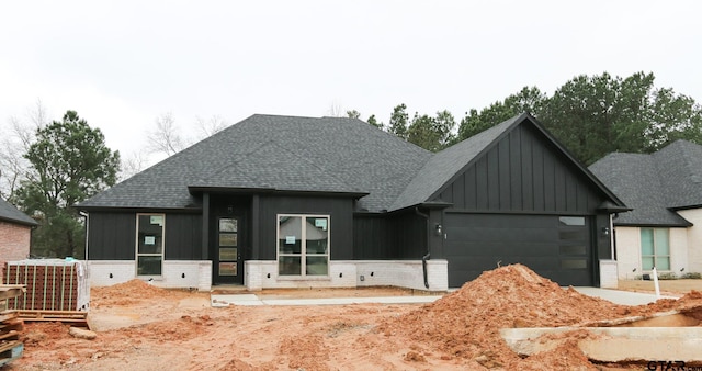 view of front of home with a garage and central air condition unit