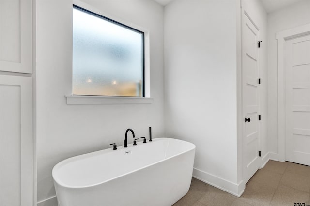 20224 Roebuck Dr, Bullard, TX 75757 - bathroom featuring a soaking tub and baseboards