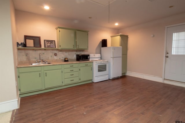 kitchen with dark wood-type flooring, sink, green cabinets, white appliances, and decorative backsplash