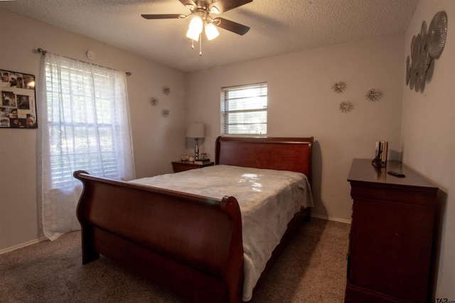 carpeted bedroom with multiple windows, a textured ceiling, and ceiling fan