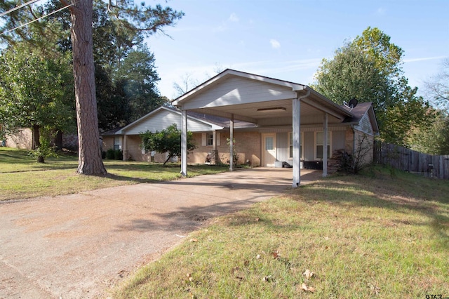 view of front of house featuring a carport and a front lawn