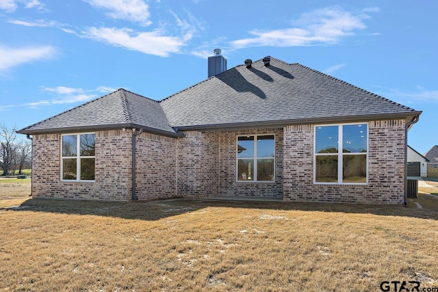 rear view of property featuring a yard