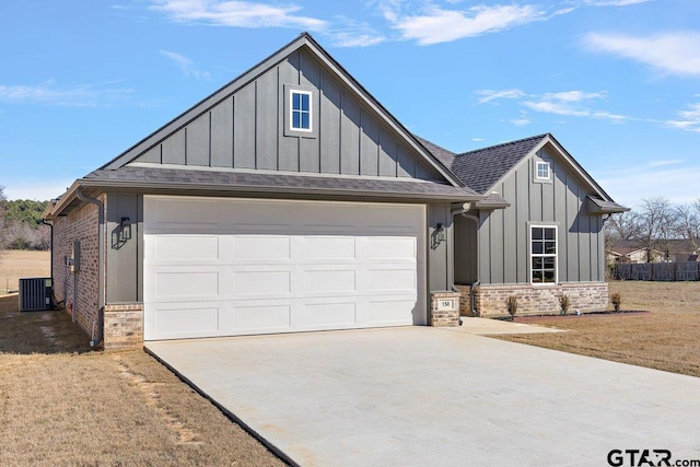 view of front facade with central air condition unit, a front lawn, and a garage