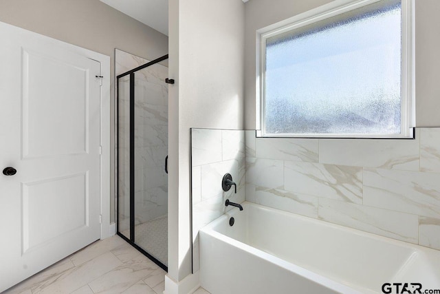 bathroom featuring separate shower and tub