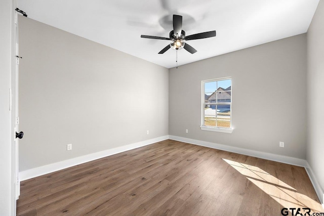 empty room featuring hardwood / wood-style floors and ceiling fan