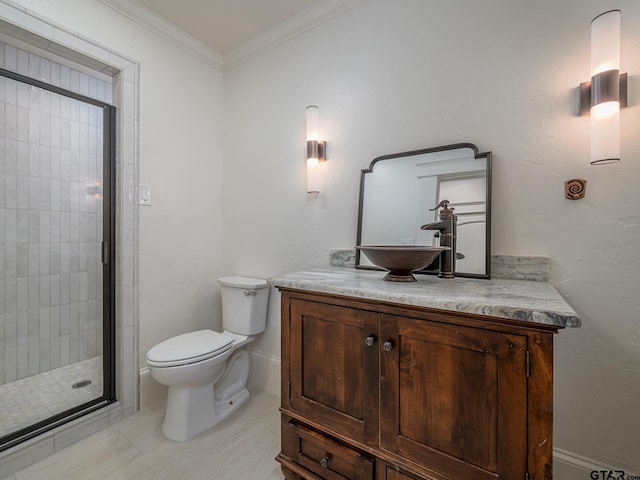 bathroom with vanity, a shower with door, ornamental molding, and toilet