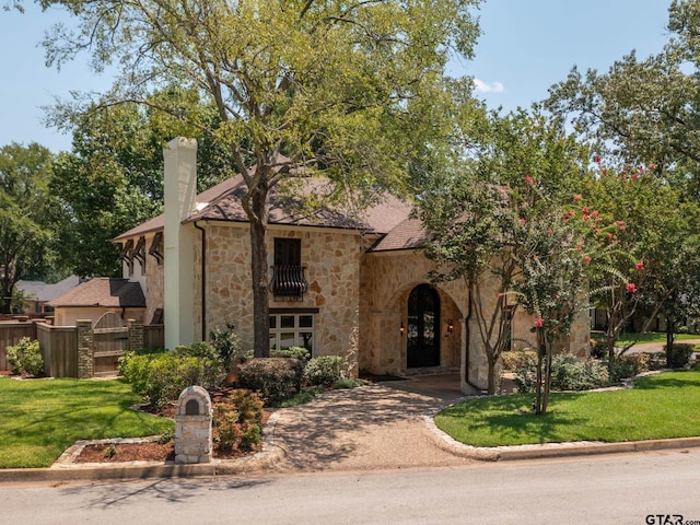 mediterranean / spanish-style house featuring a front yard