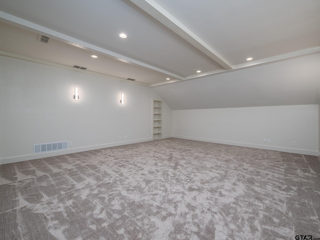 bonus room featuring built in shelves, carpet flooring, and lofted ceiling with beams