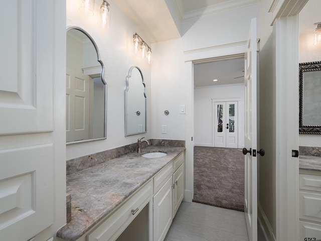 bathroom with crown molding and vanity