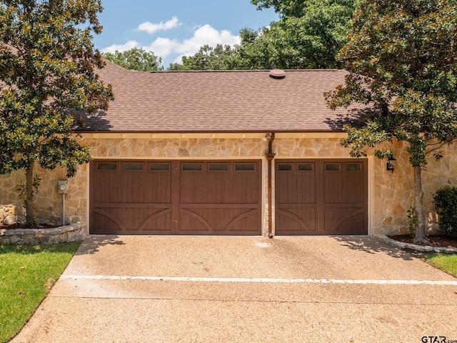 7201 Pinetree Pl, Tyler, TX 75703 - view of front of house with stone siding, a shingled roof, concrete driveway, and an attached garage