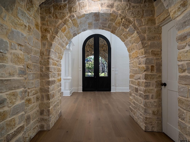 interior space with hardwood / wood-style flooring and french doors