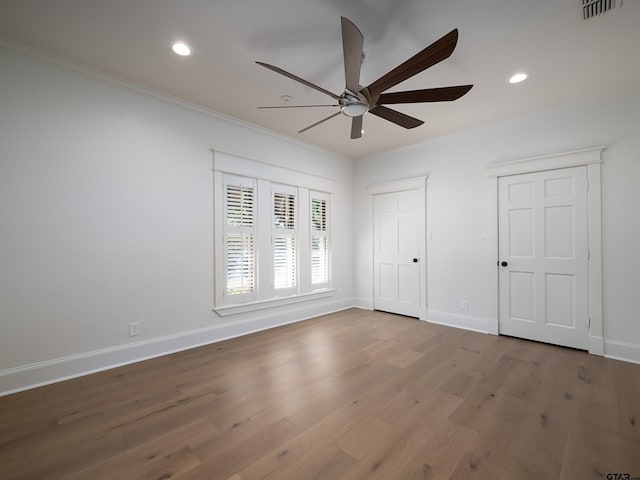 unfurnished bedroom featuring ornamental molding, wood-type flooring, and ceiling fan