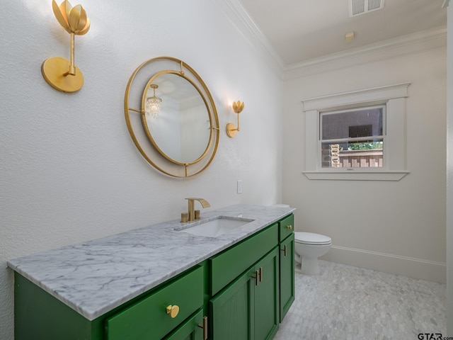 bathroom with ornamental molding, toilet, and vanity