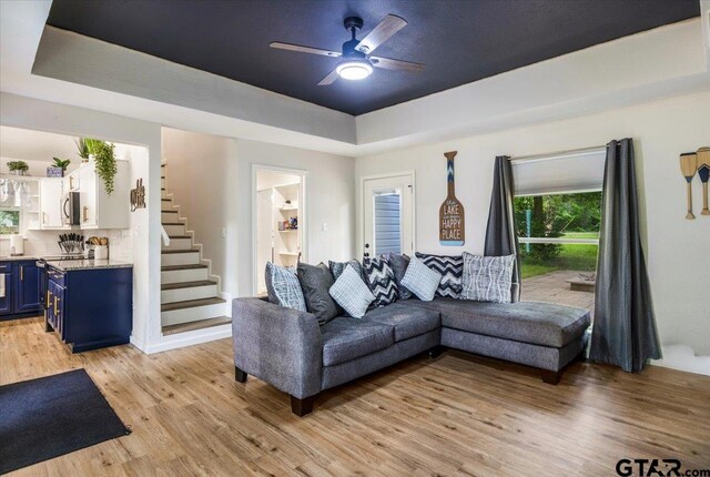 194 Debra Dr, Bullard, TX 75757 - living area with stairway, ceiling fan, a raised ceiling, and light wood-type flooring