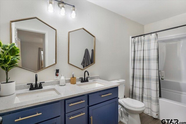 194 Debra Dr, Bullard, TX 75757 - bathroom featuring double vanity, toilet, wood finished floors, and shower / bathtub combination with curtain