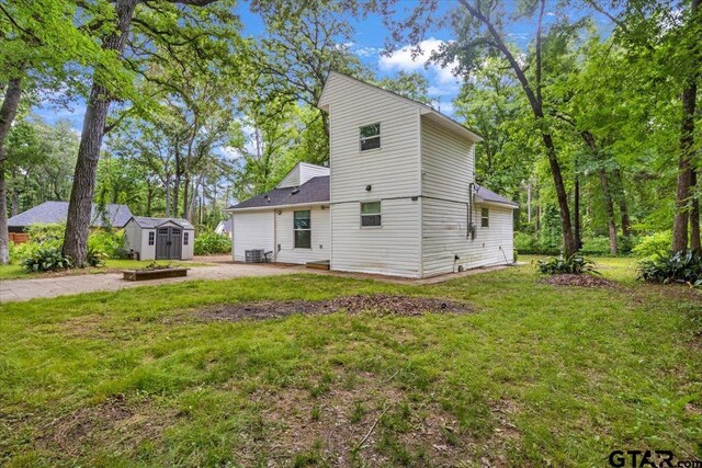 194 Debra Dr, Bullard, TX 75757 - back of house with a storage shed, an outdoor structure, a patio area, a yard, and cooling unit