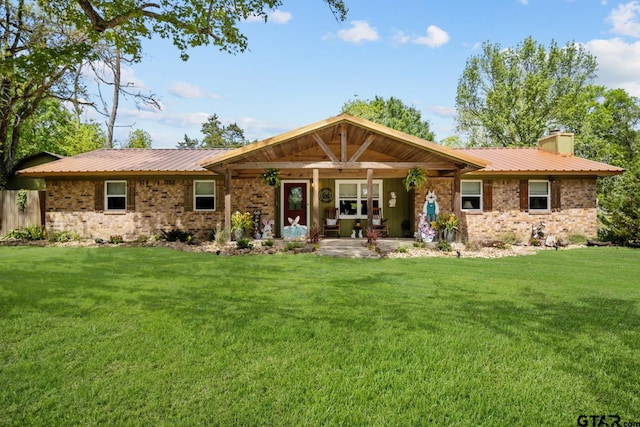 rear view of property with a yard