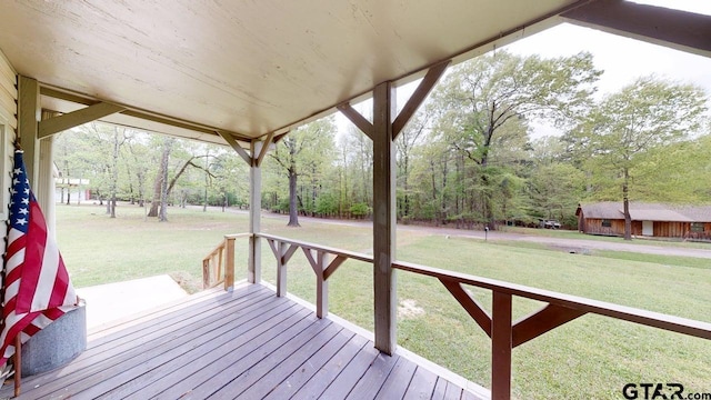wooden terrace with a lawn