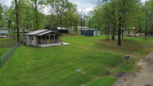 view of yard with an outbuilding and fence