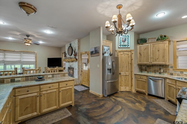 kitchen with appliances with stainless steel finishes, backsplash, decorative light fixtures, and vaulted ceiling