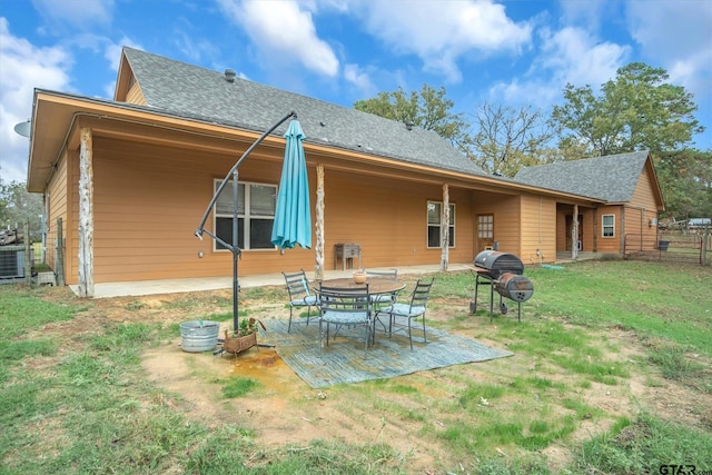 rear view of house featuring a yard and a patio area