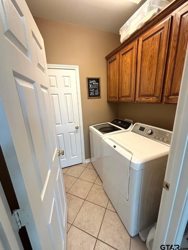 18378 Whipporwill Ln, Flint, TX 75762 - laundry area featuring washer and dryer, cabinet space, and light tile patterned floors