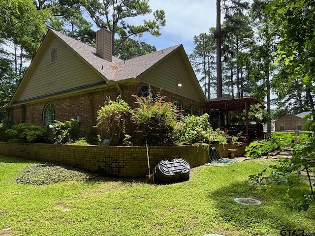 18378 Whipporwill Ln, Flint, TX 75762 - view of side of home with a yard, a chimney, brick siding, and roof with shingles