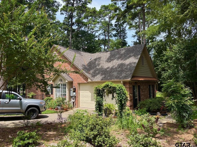 18378 Whipporwill Ln, Flint, TX 75762 - view of front of house featuring concrete driveway, an attached garage, brick siding, and a shingled roof
