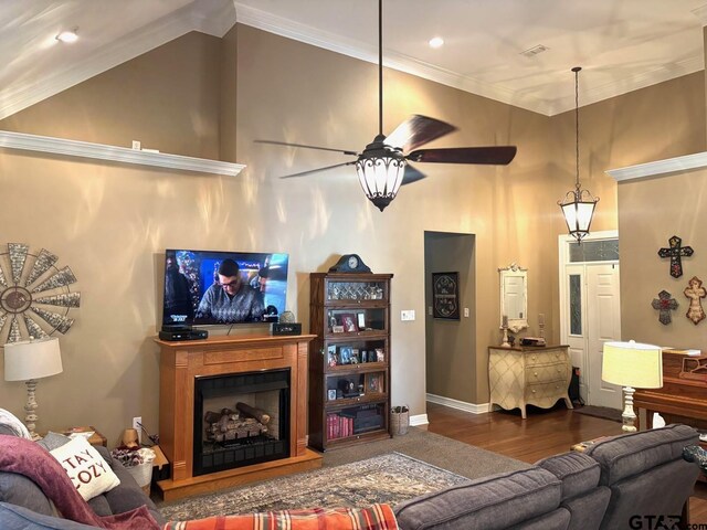 18378 Whipporwill Ln, Flint, TX 75762 - living area with wood finished floors, a ceiling fan, a fireplace with raised hearth, and crown molding