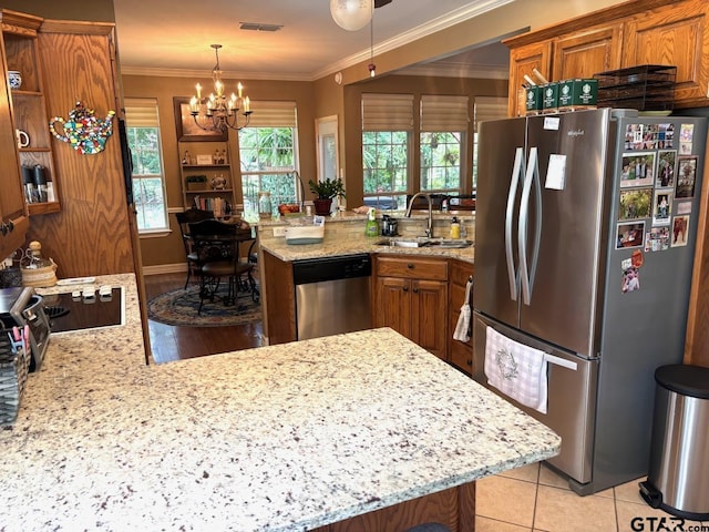18378 Whipporwill Ln, Flint, TX 75762 - kitchen with appliances with stainless steel finishes, a peninsula, brown cabinetry, a chandelier, and light stone counters