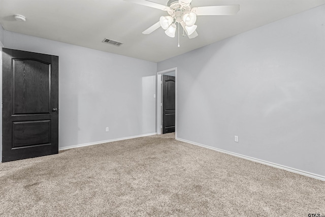 empty room with ceiling fan and carpet flooring