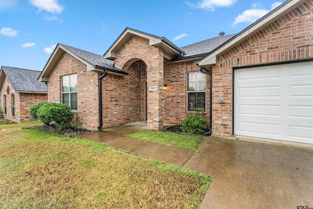 single story home featuring a garage and a front lawn