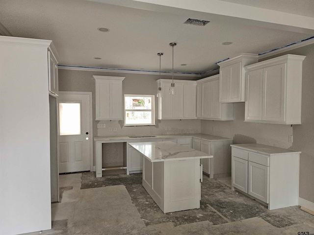 kitchen featuring crown molding, white cabinetry, a kitchen island, and hanging light fixtures