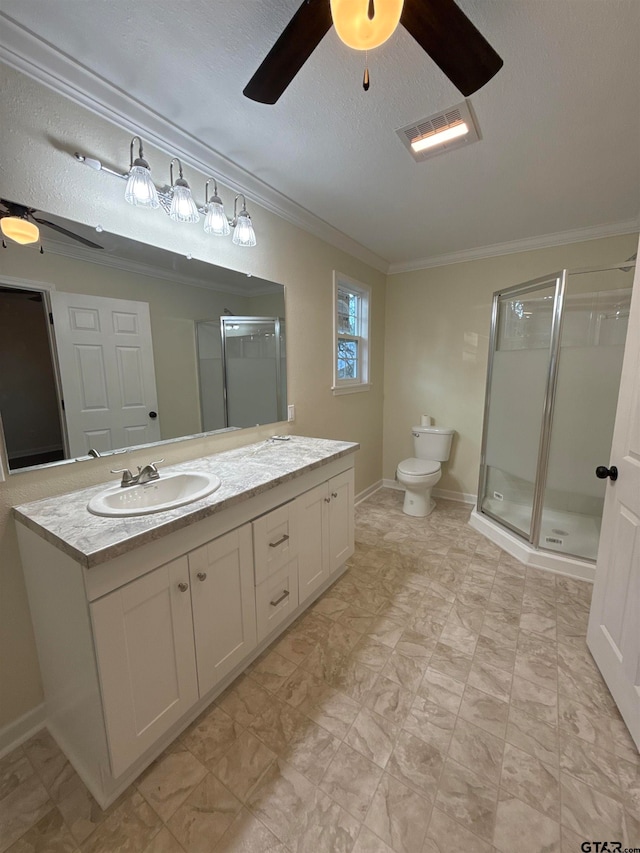 bathroom with vanity, a textured ceiling, a shower with door, and ornamental molding