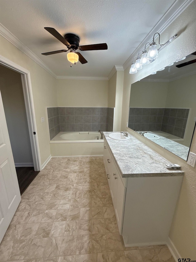 bathroom with vanity, a textured ceiling, a relaxing tiled tub, and ornamental molding