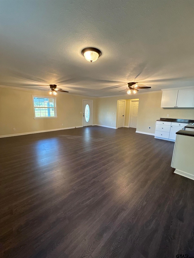 unfurnished living room featuring a textured ceiling, dark hardwood / wood-style flooring, and ceiling fan