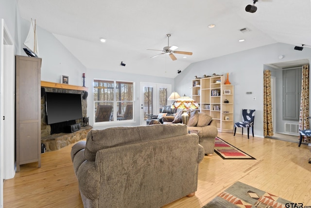 living area with lofted ceiling, light wood-style flooring, visible vents, and ceiling fan