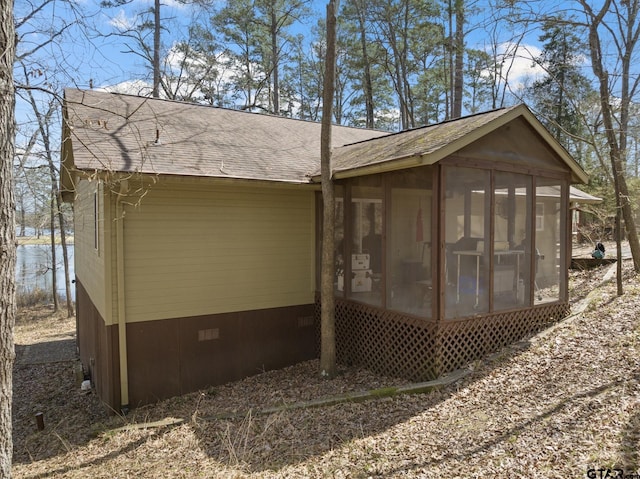 view of outdoor structure featuring a sunroom