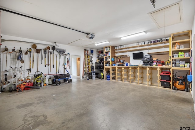 213 Coventry St, Bullard, TX 75757 - garage featuring a garage door opener and a workshop area