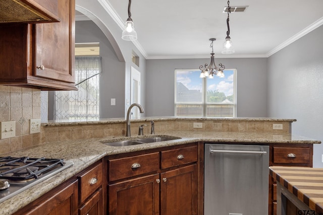 213 Coventry St, Bullard, TX 75757 - kitchen featuring appliances with stainless steel finishes, pendant lighting, crown molding, light stone countertops, and backsplash