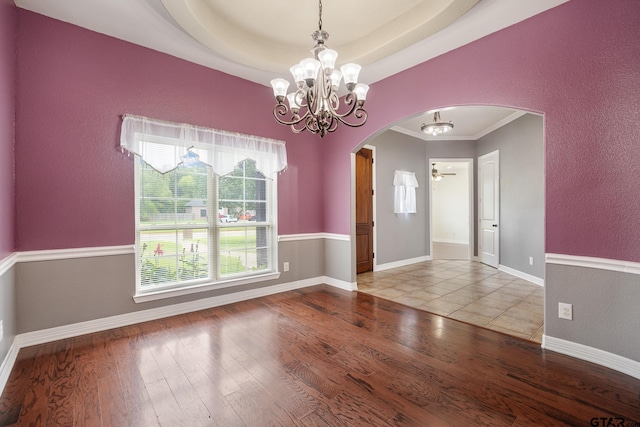 213 Coventry St, Bullard, TX 75757 - spare room with arched walkways, a chandelier, wood finished floors, a textured wall, and crown molding