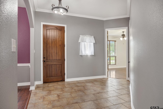 213 Coventry St, Bullard, TX 75757 - entrance foyer featuring crown molding, light stone finish floors, a textured wall, ceiling fan, and arched walkways