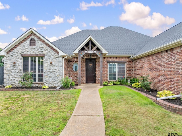 213 Coventry St, Bullard, TX 75757 - view of front facade featuring a front lawn, a shingled roof, stone siding, and brick siding