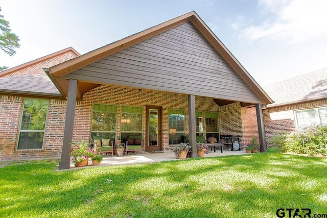 13452 Karah Ln, Lindale, TX 75771 - rear view of property featuring brick siding, a patio, and a yard