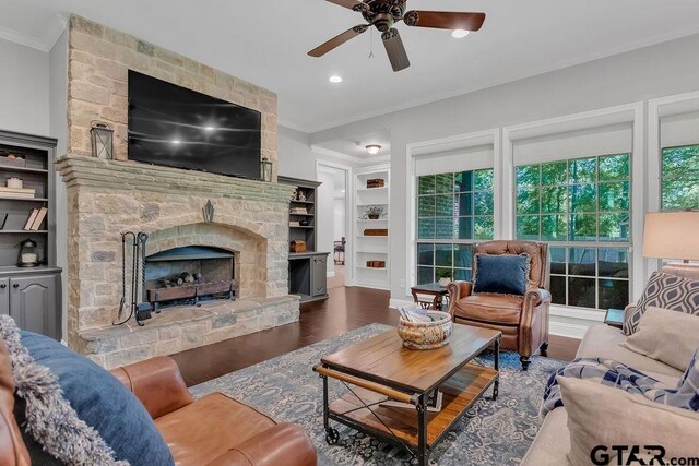 13452 Karah Ln, Lindale, TX 75771 - living area featuring ornamental molding, wood finished floors, a ceiling fan, a fireplace, and built in shelves