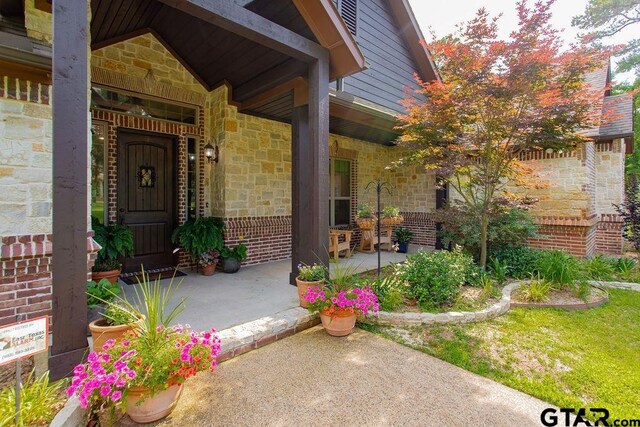 13452 Karah Ln, Lindale, TX 75771 - entrance to property with covered porch, stone siding, and brick siding